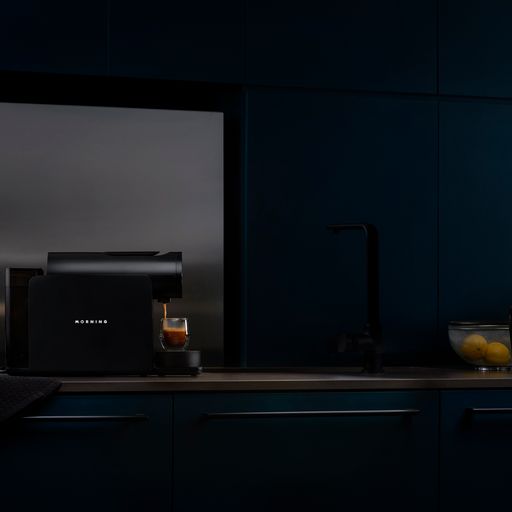 Black Morning Coffee Machine with OLED screen displaying temperature setting via mobile app. Brewing using 'Breakfast Club' coffee capsules for a delicious morning cup. Upgrade your coffee game with the Morning Coffee Machine.